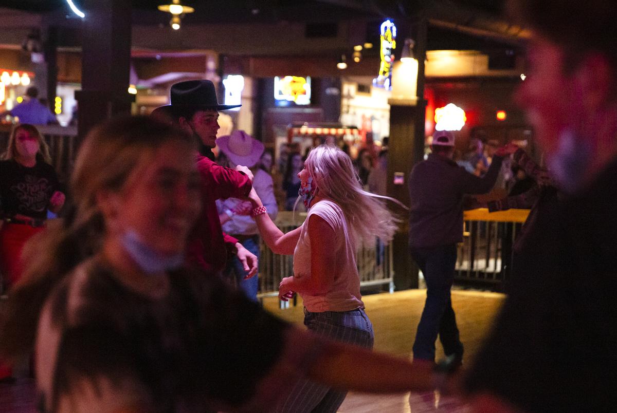 Guests dance at Billy Bobís Texas, a honky-tonk in Fort Worth. Billy Bobís has been operating since August 13 under food and beverage guidelines after previously being classified as a bar. Bars that did not already get the food and beverage license were allowed to reopen October 14 at 50% capacity, and must stop selling alcohol by 11 pm.