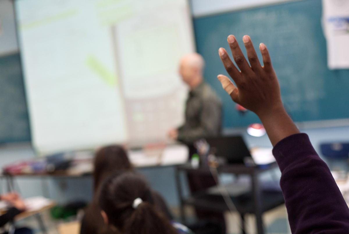 FILE: A student in Austin raises a hand in class in April 2013.