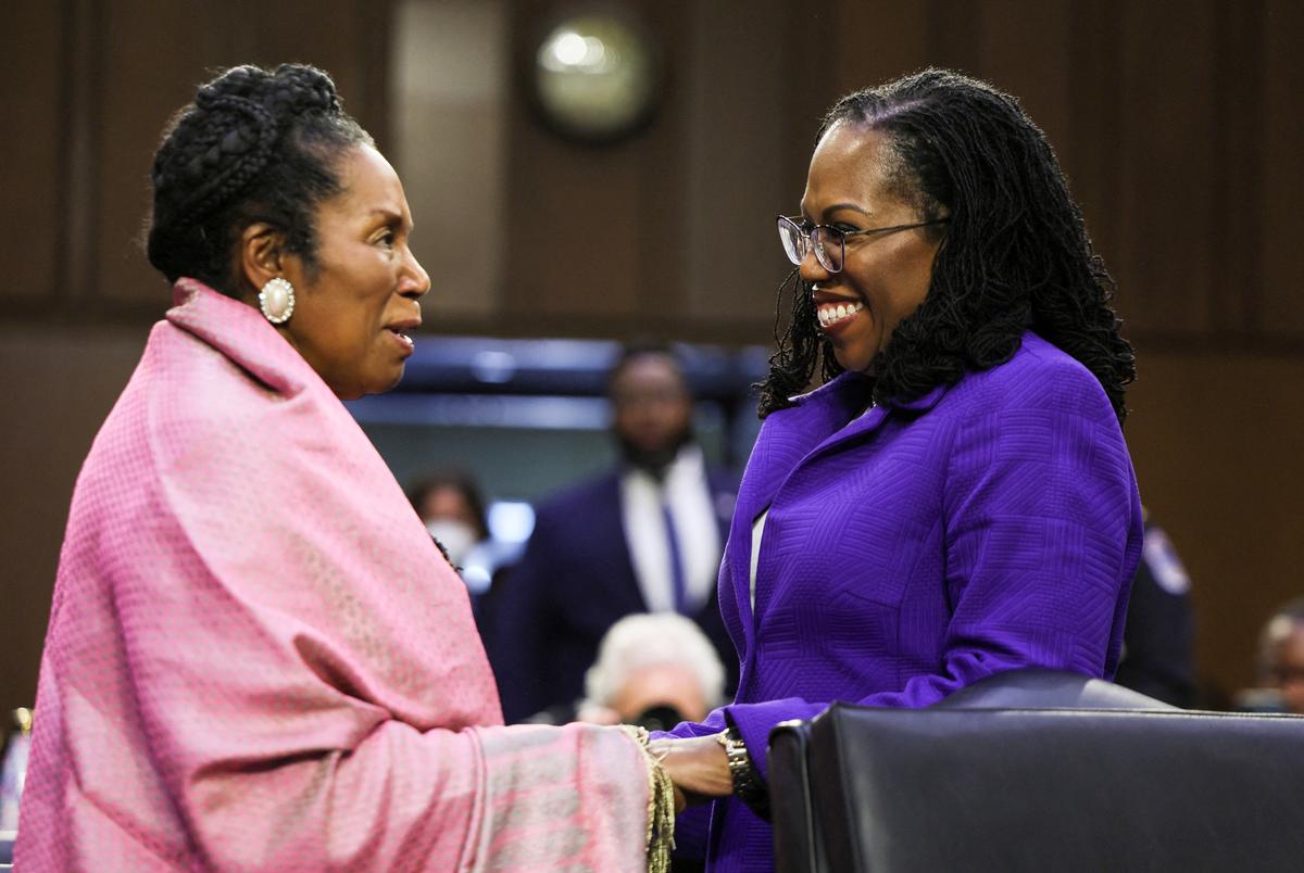Judge Ketanji Brown Jackson, R, is greeted by U.S. Rep. Sheila Jackson Lee, D-TX, at a Senate Judiciary Committee confirmation hearing on Jackson's nomination to the U.S. Supreme Court, on Capitol Hill in Washington on March 21, 2022.