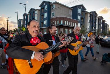 A procession, organized by the Esperanza Center, makes its way towards the Alazan-Apache Courts, a historic public housing neighborhood in San Antonio's West side.