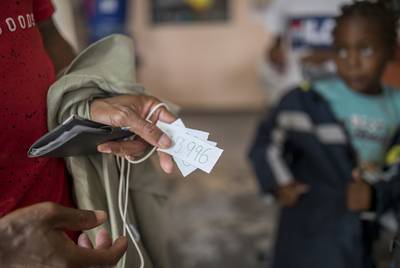 Roberto Kabuya Mutombo shows his and his families number of the waiting list to enter the U.S. in the rectory at the migrant Center at the migrant shelter, El Buen Pastor, Monday, May 13, 2019, in Ciudad Juarez. Mutombo and his family, not pictured, just arrived to the border city. They are from Angola. Photo by Ivan Pierre Aguirre for The Texas Tribune