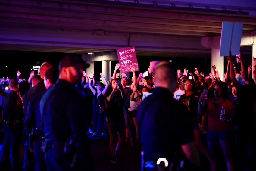 Protesters raise their hands at the intersection of Midkiff Road and Highway Loop 250 during a Black Lives Matter protest in Midland on May 31st 2020.