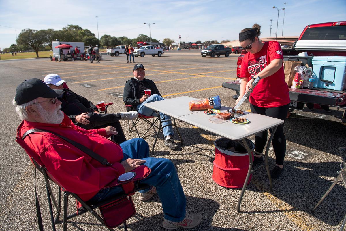 Aaron Ramsey prepares food for family and friends at their tailgate party before Texas Tech's home coming game against West Virginia at Texas Tech University on Saturday. Oct. 24, 2020. 