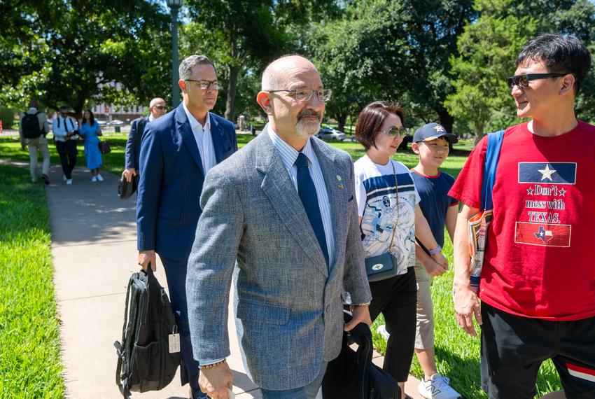 Texas Democrats Jon Rosenthal, D-Houston and Rafael Anchia, D-Dallas, l,  get off a charter bus from the Austin airport outside the State Archives building on the east side of the Texas Capitol upon their return to Austin following a two-week quorum break.  Man at right is unidentified.