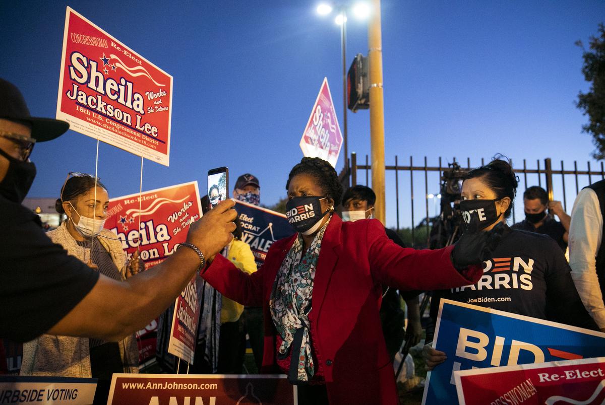 Congresswoman Sheila Jackson Lee, center, joins the family of George Floyd in cheering on Biden supporters outside of the Metropolitan Multi-Services Center during Election Day in Houston on Nov. 3, 2020.