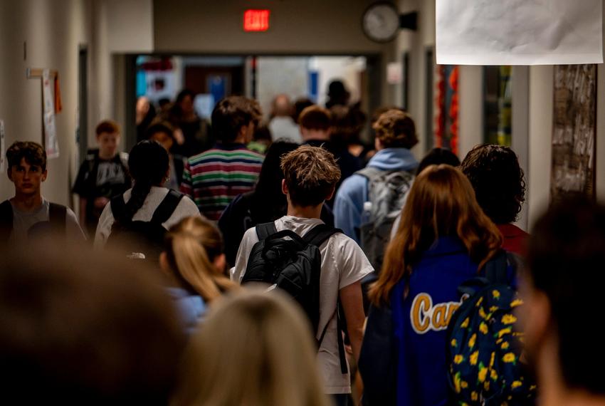 Students walk through the hallway at Lago Vista High School on Tuesday, Sept. 9, 2025 in Lago Vista, TX. HB 1481 passed during the special legislative session which requires schools to implement a policy prohibiting personal communication devices. Lago Vista has implemented a policy where students stow devices, primarily cell phones, in magnetically locked pouches that also block cell phone service, the devices can be unlocked in the event of an emergency as well as when the students exit the building using a wall mounted key near the building entrance.