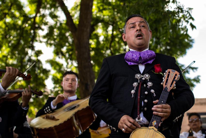 Several mariachi musicians perform at the Town Square memorial where thousands of flowers, notes, toys and stuffed animals were placed in front of wooden crosses with the victim’s names on them in Uvalde on June 1, 2022.