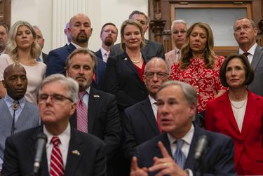 Legislators watch as Lt. Gov. Dan Patrick and Gov. Greg Abbott share updates on their plan for Texas to build its own border wall at a press conference at the Texas Capitol on June 16, 2021.