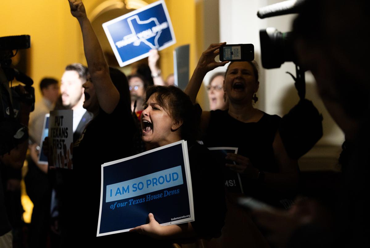 A crowd cheers as representatives walk into the Texas House on Aug. 18, 2025. Texas Democrats left the state to fight redistricting at the national level, returning after two weeks.
