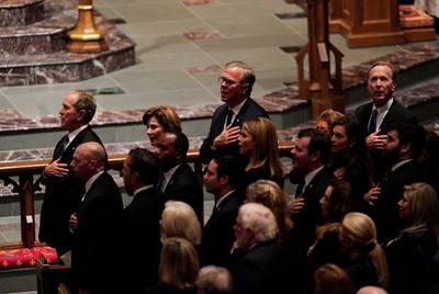 Members of the Bush family, including former U.S. President George W. Bush, former first lady Laura Bush, Jeb Bush and Neil Bush, sing the U.S. National Anthem inside the St. Martin's Episcopal Church during the funeral service for former U.S. President George H.W. Bush on Dec. 6, 2018 in Houston.