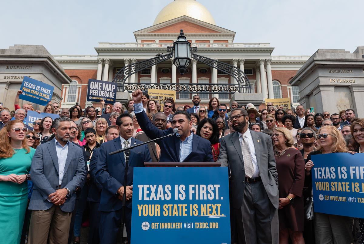 Surrounded by Democratic state representatives from all over the country, state Rep. Armando Walle, D-Houston, speaks at a press conference on the front steps of the Massachusetts State House in Boston on the 60th anniversary of the Voting Rights Act, on Wednesday, August 6, 2025.