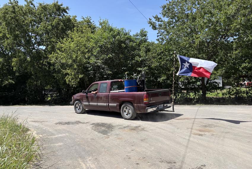 Allen Davis, a volunteer from Marble Falls, hauls a 55-gallon drum of fuel for debris-clearing equipment on July 17, 2025. He arrived in Sandy Creek on July 8, supported by donations from residents of El Paso.