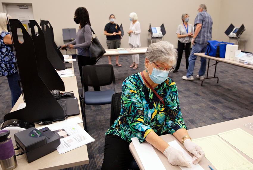 Poll worker Jean Anthony runs through the voter check-in system at a training lab at the Collin County Elections Department on June 23.