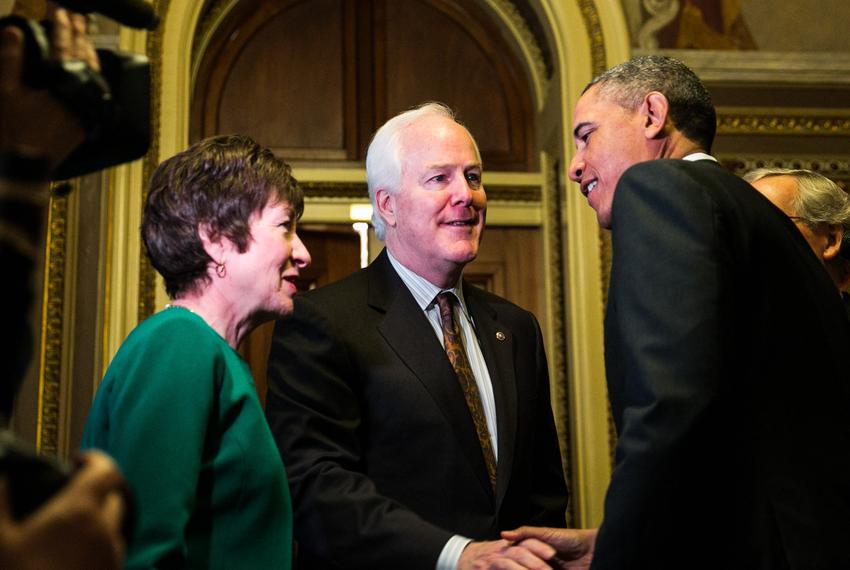 President Barack Obama is greeted by U.S. Sens. Susan Collins, R-Maine, and John Cornyn, R-Texas, as he arrives at the U.S. Capitol to meet with Senate Republicans, on Capitol Hill in Washington, D.C., on March 14, 2013.