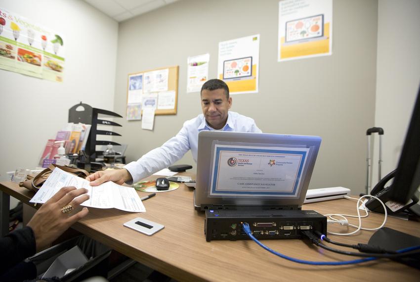 Central Texas Food Bank Social Services Coordinator Eddie Sanchez meets with a client at Central Health Southeast Health and Wellness Center in Austin on Nov. 29, 2017