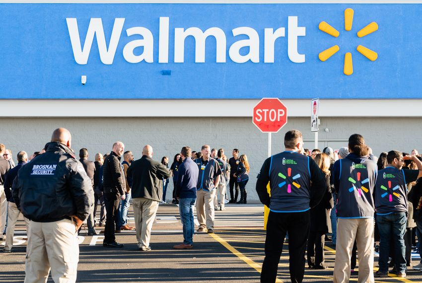 Flanked by security, workers at the Cielo Vista Walmart in El Paso prepare for the store to reopen Thursday.