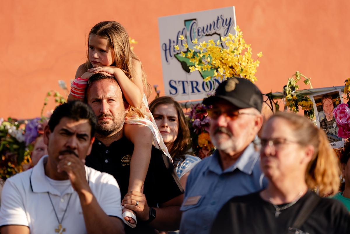 Members of the community honor the victims of the flood with a vigil and a memorial on Water St. in Kerrville on Friday July 11, 2025.