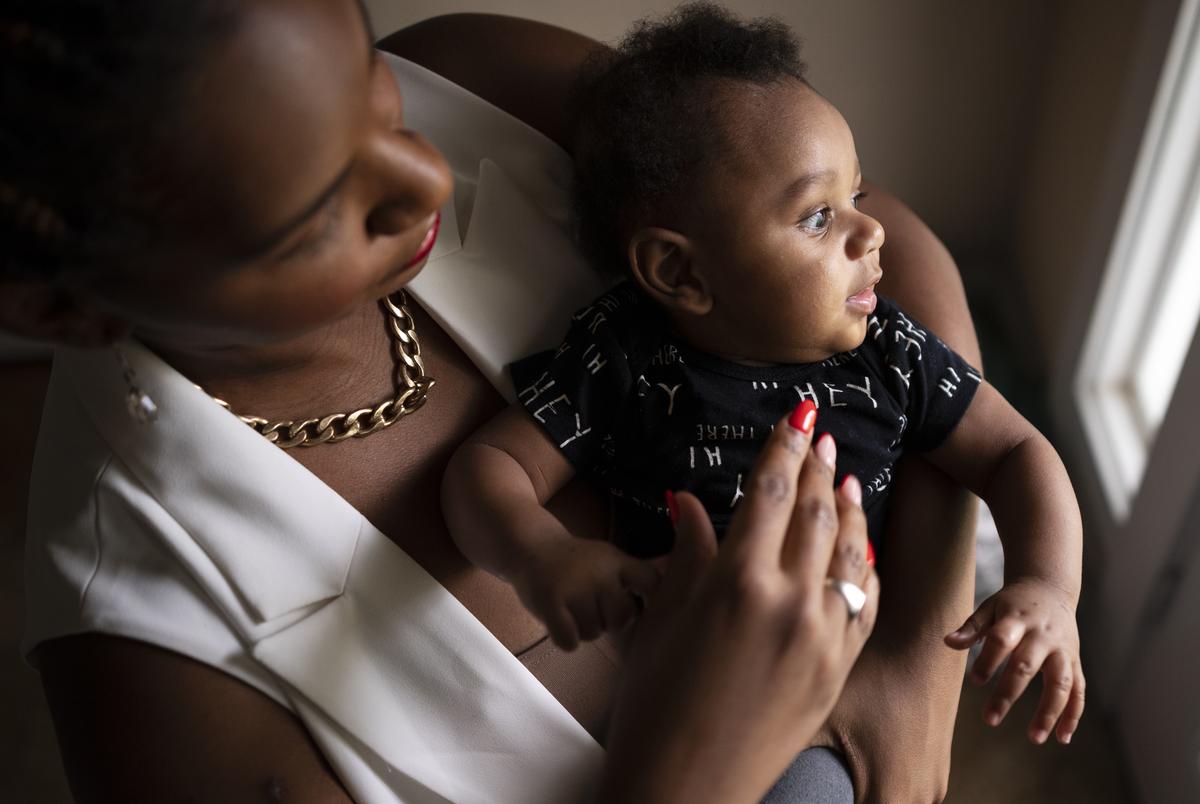 Lauren Lewis with her four-month-old baby Langston Lewis at their home in Dallas on Sept. 14, 2021. Lauren was infected with COVID-19 while three months pregnant with Langston. Lauren was vaccinated in January before giving birth to him in April.