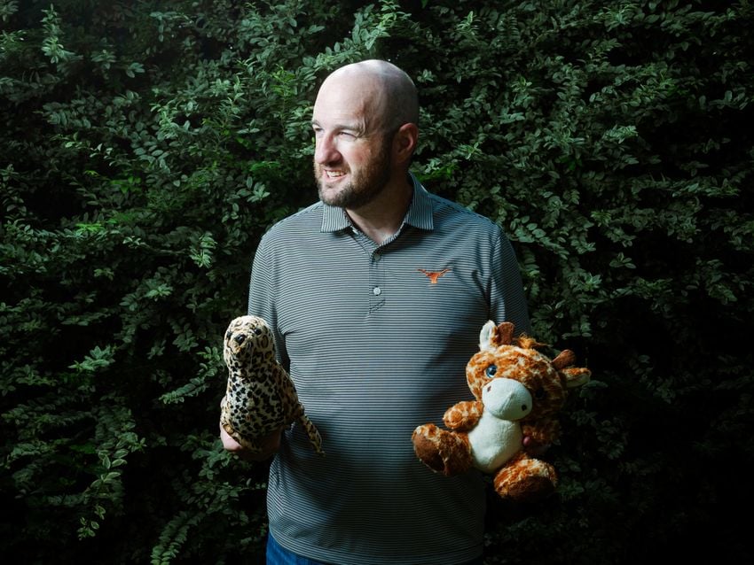 Danny McDonald, an attorney in Boerne, holds a stuffed giraffe and a stuffed seal he found while volunteering in search efforts in the aftermath of the Kerr County flood.
