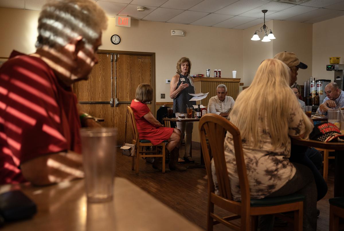 Annette Maruska, president of the East Williamson County Republicans, center, welcomes members to a meeting Thursday, July 18, 2024 in Taylor.