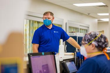 David Lee, Chief Executive Officer, at Otto Kaiser Memorial Hospital in Kenedy speaks with staff in the ER.
