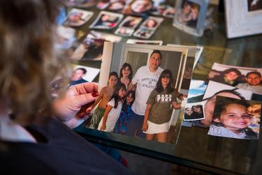 Michelle Tennen looks at family photographs at her home in El Paso. Tennen's daughter Charley died by suicide in July 2020.