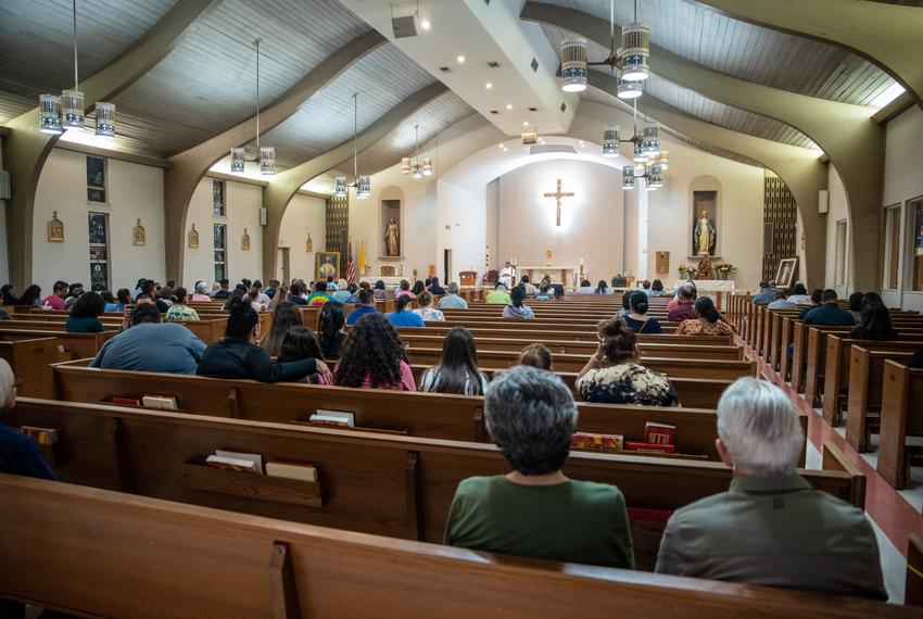 Community members gather inside Sacred Heart Church for prayer after a school shooting on Tuesday, May 24, 2022 in Uvalde, TX. A school shooting was reported this afternoon after a high school student opened fire inside Robb Elementary School where two teachers and 14 students were killed.