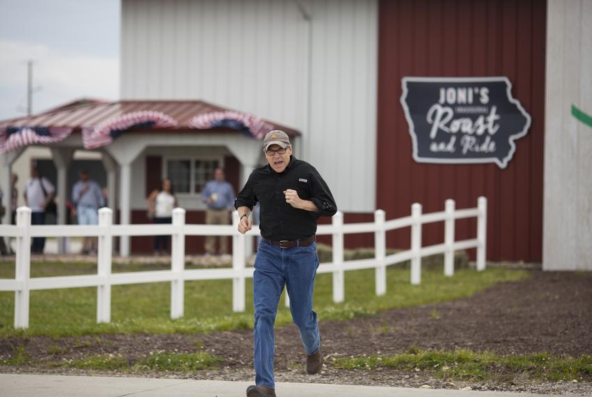 Rick Perry runs to the stage at the Roast and Ride in Boone, Iowa.