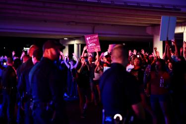 Demonstrators raised their hands at May 31 protest in Midland.