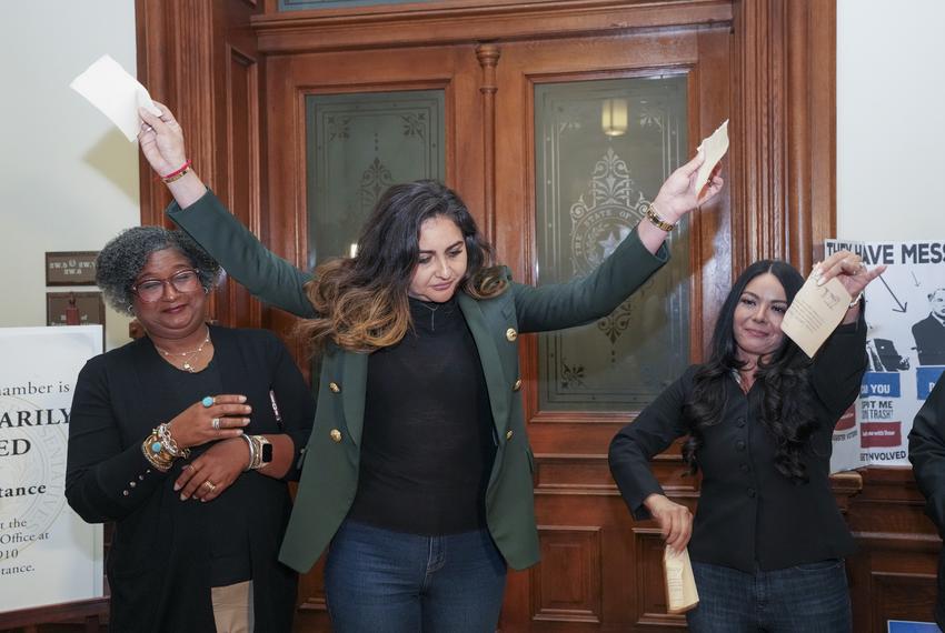 State Rep. Mihaela Plesa, D-Plano, rips up her "permission slip" in front of the Texas House vowing she will stay the night in the House Chamber in support of fellow Democrat Nicole Collier on August 19, 2025. At left is Rep. Rhetta Bowers, D-Garland, at right is Rep. Cassandra Hernandez, D-Farmer's Branch.