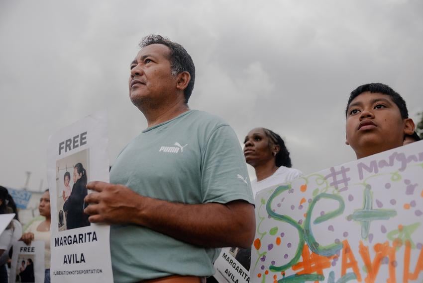José and his son, Isaac attend a FIEL action in front of the Core Civic Processing Center where Margarita Avila and others are being detained, Friday, June 13, 2025, in Houston. The action focused on the increase in detentions, and let those inside the facility feel that they were not alone. 

(Lexi Parra for The Texas Tribune)