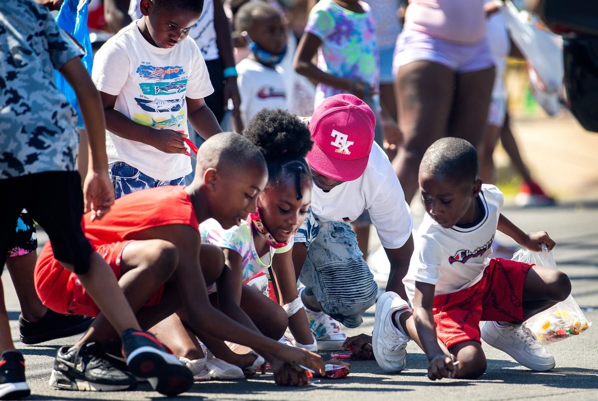 Children scramble for candy during the annual Juneteenth parade in East Austin on June 19, 2021. Juneteenth commemorates Union Army General Gordon Granger’s proclamation issued on June 19, 1865 in Galveston, which ordered the freedom of more than 250,000 enslaved Black people in Texas who were denied freedom for more than two years after President Abraham Lincoln signed the Emancipation Proclamation.