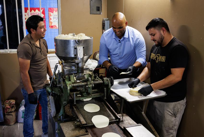 Samuel Garcia, left, talks to former U.S. Rep. Colin Allred and his brother-in-law Rodolfo Garcia while they make corn tortillas at Nando¥s Tortilleria y Restaurante at Pulga Los Portales in Alton on Oct. 2, 2025.