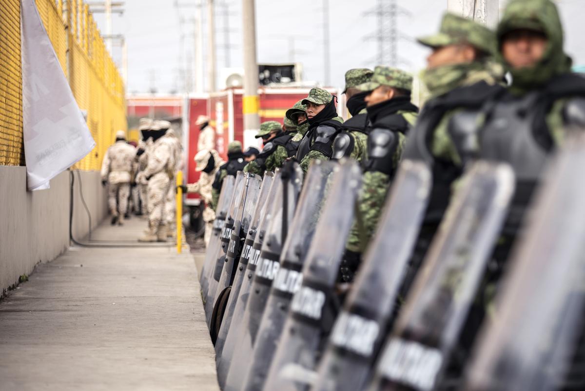 The Mexican military guards the perimieter of the shelter where an estimated 1700 migrants are currently being held in Piedras Negras. Feb. 12, 2019. 