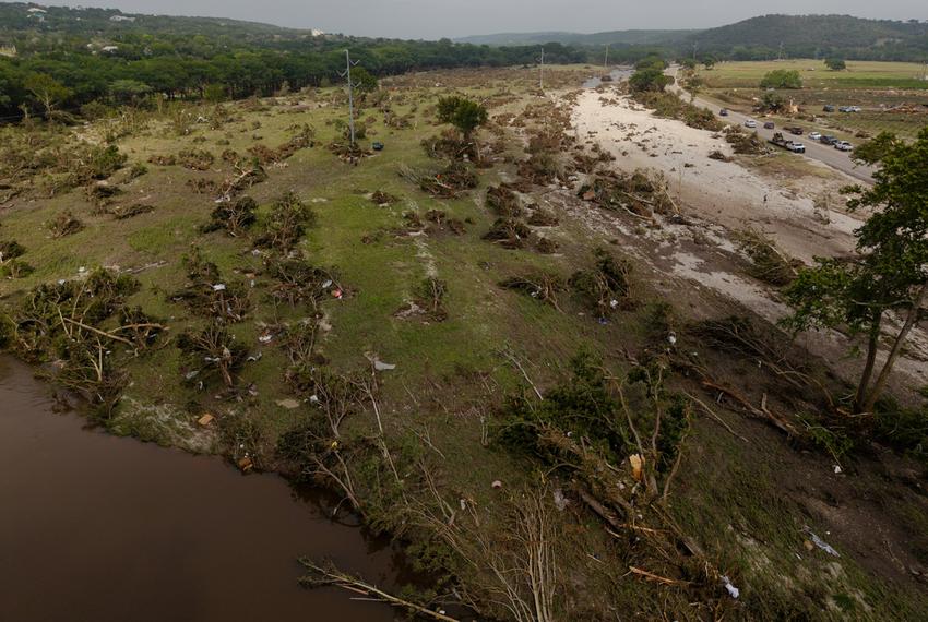 A July 5 aerial view of toppled trees near Hunt reveal the scope of the devastating July 4th flood in Kerr Co. Texts and emails show local officials were slow to grasp the severity of the disaster.
