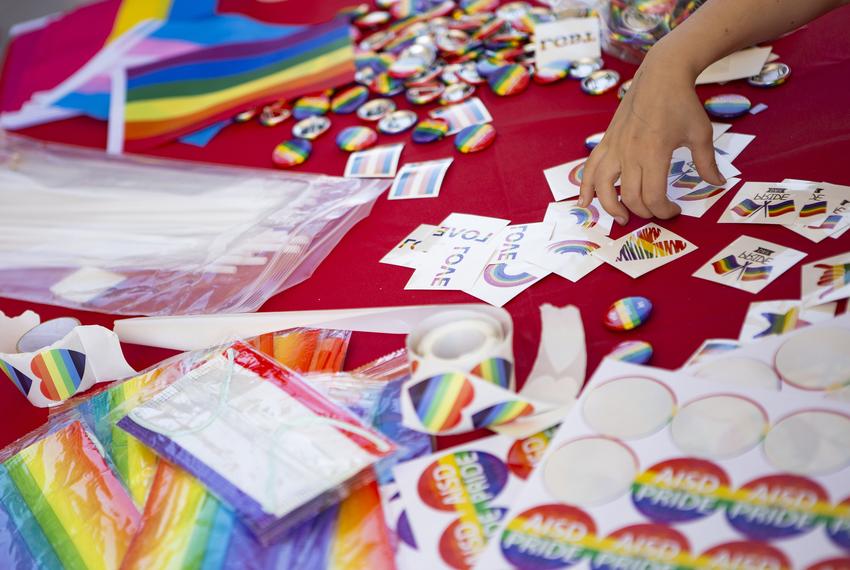 Pride flags, stickers and masks, pronoun buttons and other merch are handed out at the AISD "Pride Out!" Party in the Park event at Eastside Early College High School in Austin on March 26, 2022.