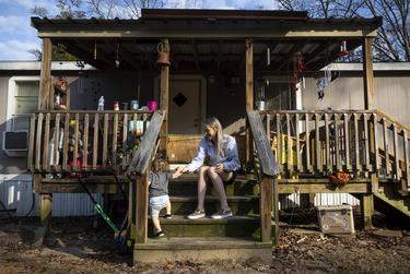 Chloe Walker and her sixteen-month old daughter, Everleigh, play outside their home in Newton, TX, on Jan. 3, 2023. Walker’s high-risk pregnancy forced her to have bedrest at 24 weeks and drive over two hours round-trip to see her doctor.