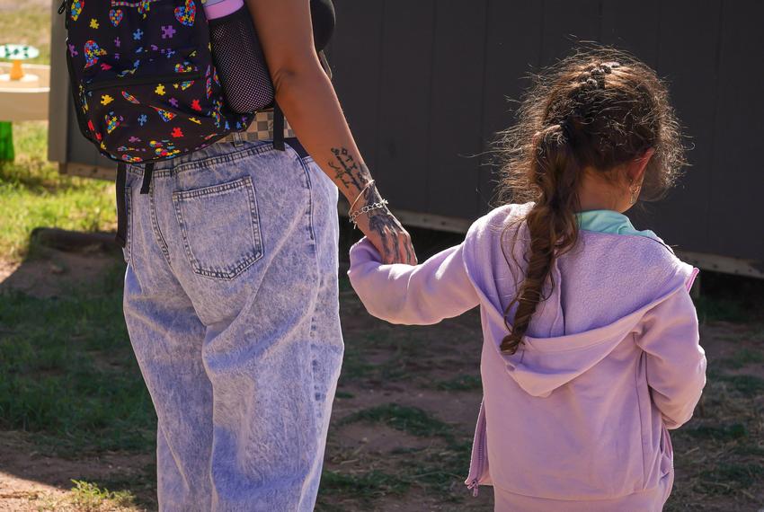 Daniela Santos and her daughter, age 4, walking hand in hand to their home in Midland, Texas on October 6, 2025. The Midland ISD SPED school bus drops the Santos girl off to her home after school.
