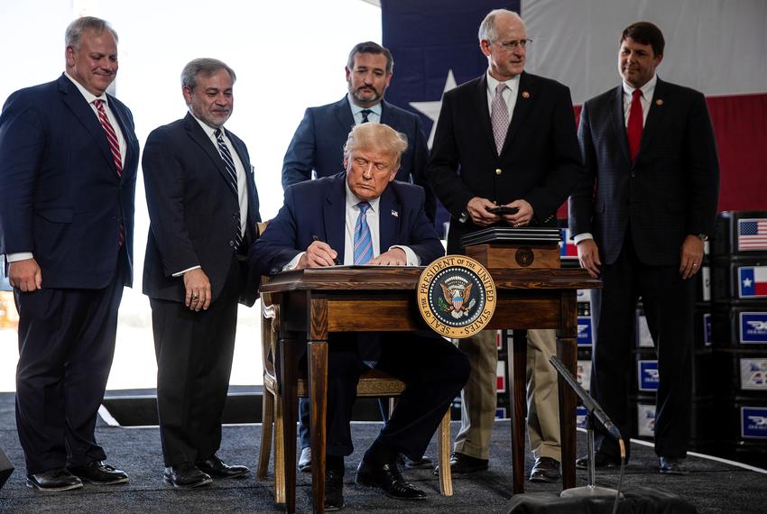 U.S. President Donald Trump signs presidential permits for energy development during a tour of the Double Eagle Energy Oil Rig in Midland on July 29, 2020.