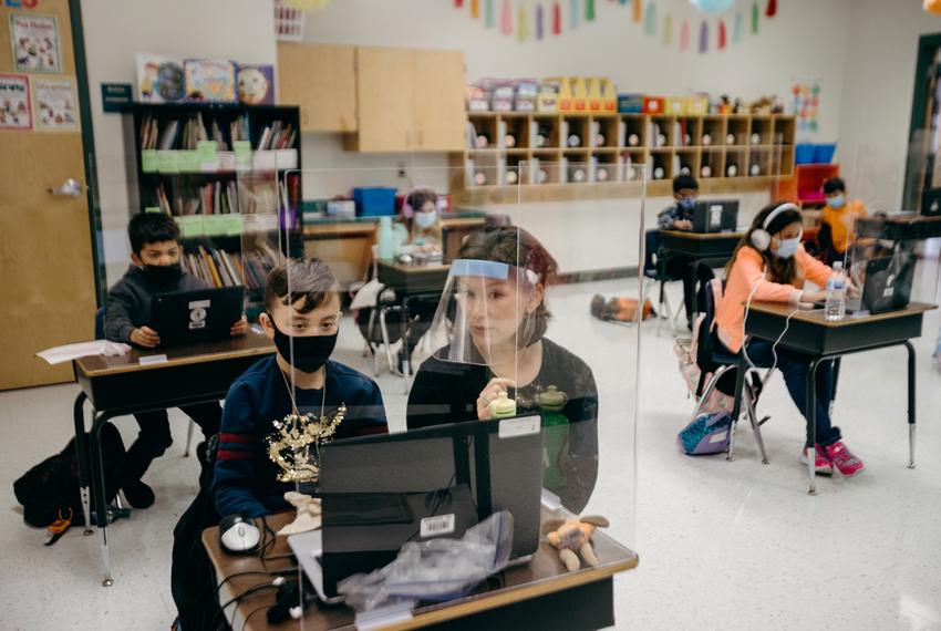 Student Kaison Hockenbarger and Ms. Abigail Boyett go over his answers to a multiplication assignment in Schoology. Schoology is an online portal and virtual learning hub, students, parents and teachers use to access assignments and communicate with their teachers outside of their classrooms.