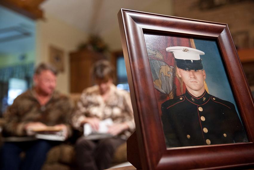 Dennis and Patty Thuesen look through photos of their son John from his childhood and his service in the military. John, an Iraq war veteran, is appealing his death sentence for the murders of his girlfriend and her brother, Rachel and Travis Joiner, claiming that lawyers at his original trial did not adequately inform jurors about his PTSD.