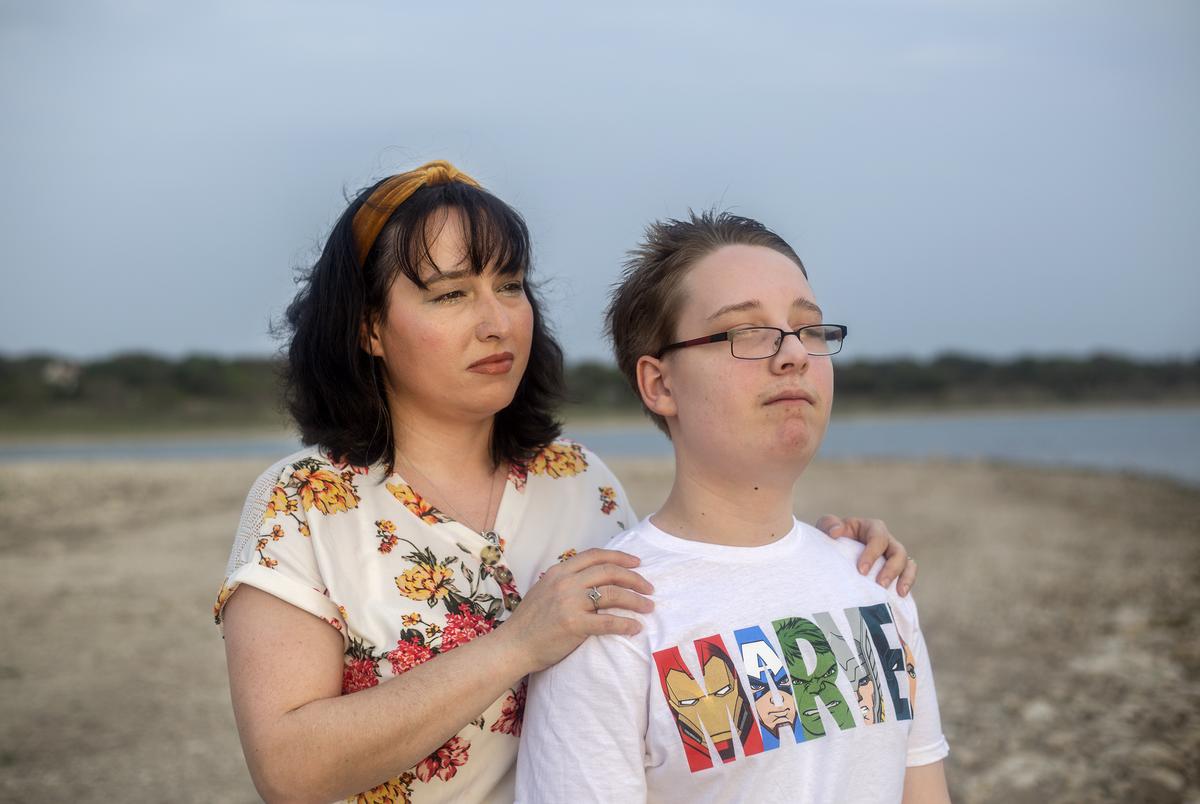 Trish and her 12-year-old son look out into the sunset at Canyon Lake on April 13, 2021.