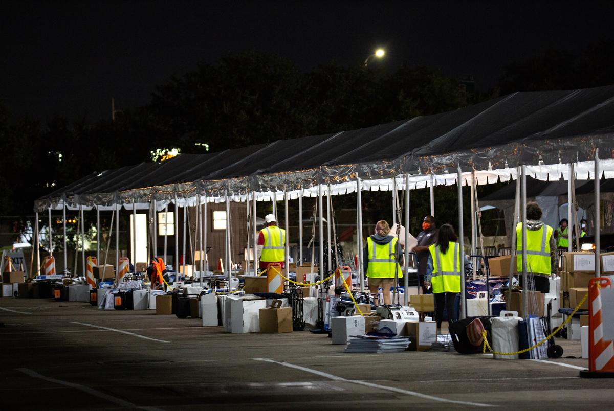 Harris County election workers process the election materials dropped off at the NRG Arena in Houston on Nov. 3, 2020.