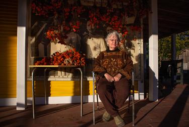 Graciela Sanchez, director of the Esperanza Peace and Justice Center, poses for a portrait outside of the Rinconcito de Esperanza in San Antonio, Texas on Nov 30. Behind her, a portrait of her mother (middle)  hangs on the wall.