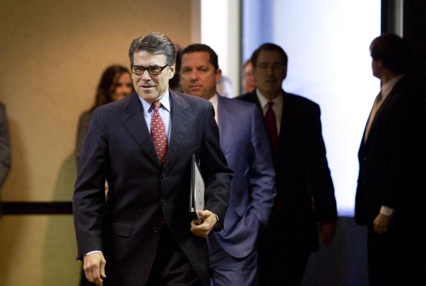 Gov. Rick Perry walks into a press conference with his legal team on Jan. 28, 2015.