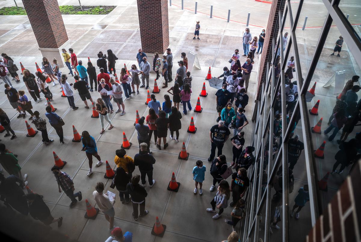 McKinney ISD students and their parents or legal guardians, wait for a COVID-19 vaccine at a site hosted by McKinney ISD and the McKinney Fire Department, on May 20, 2021.
