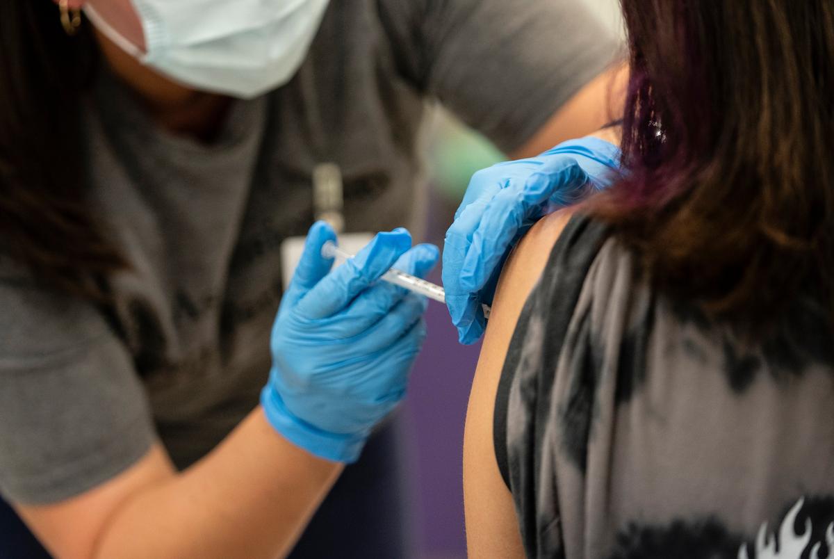 A nurse administers a dose of the Pfizer vaccine at a clinic organized by the Travis County Mobile Vaccine Collaborative at Rodriguez Elementary School on July 28, 2021.