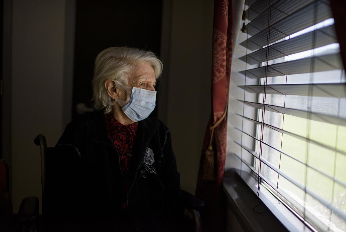 Marie Sanders looks out the window in a family visitation room at Focused Care at Humble on April 1, 2021, in Humble.