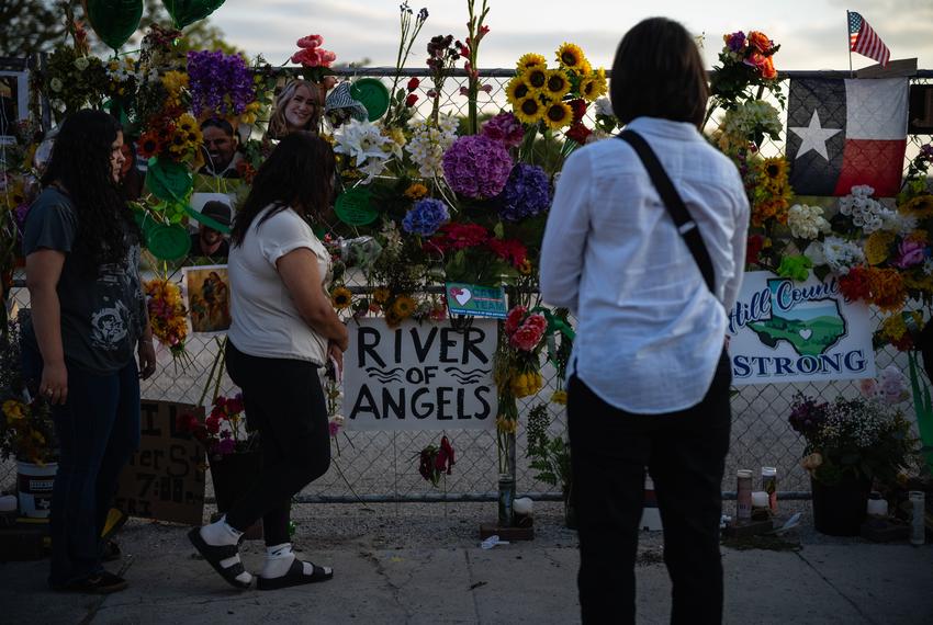 People gather at a memorial for the victims of the Kerr County flood during a vigil on Friday, July 11, 2025, in Kerrville.