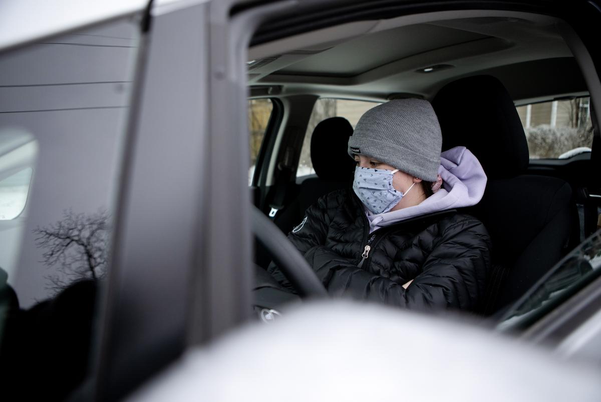 Megan Linden sits in her car to warm up and charge her phone in East Austin on Feb. 17, 2021.